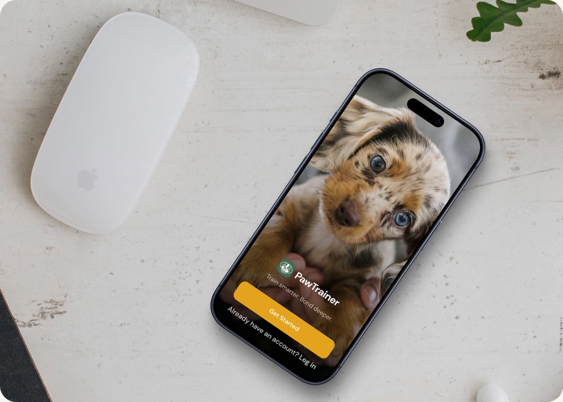 PawTrainer app shown on a phone beside a computer mouse